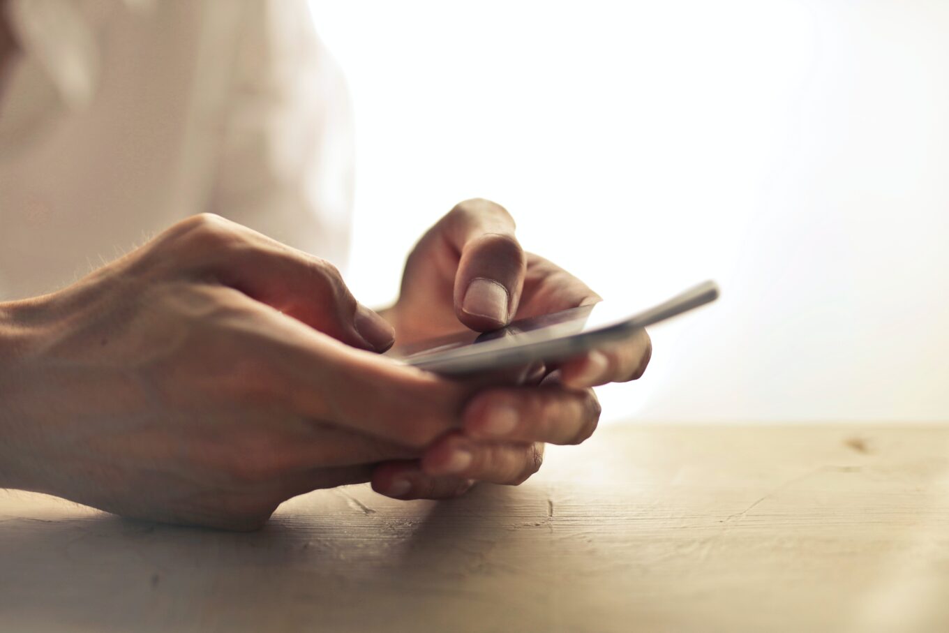 Close up photo of a mobile phone being held.