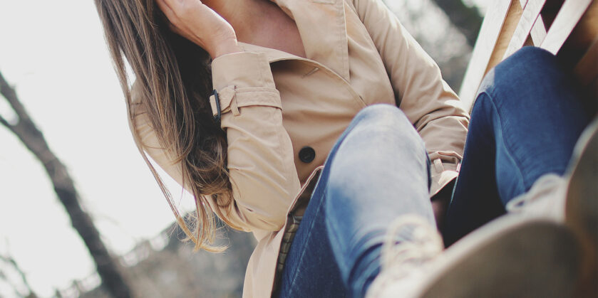 Lady holding a mobile phone up to her ear and smiling