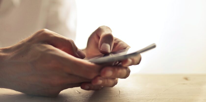 Close up photo of a mobile phone being held.